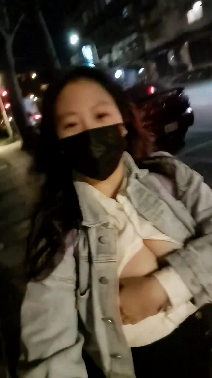 Asian girl walks with boobs out at night
