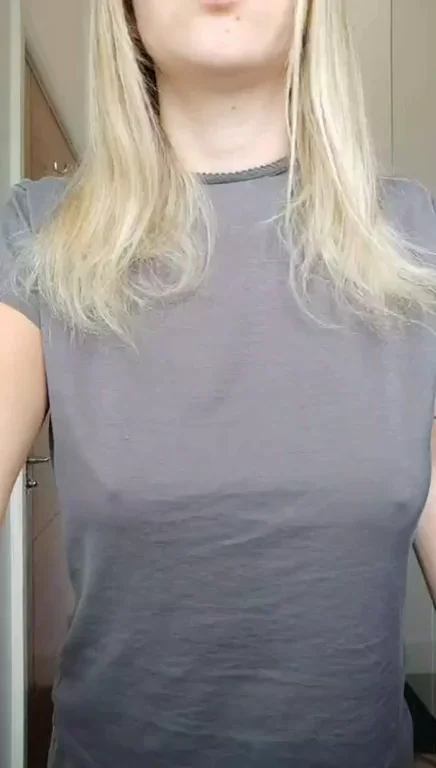 Blonde Slut Flashes Massive Tits by the Window in Grey Tee
