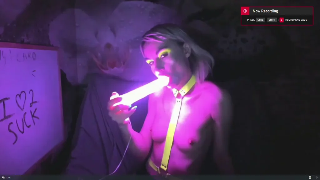 Kelly Copperfield deepthroating a glowing LED dildo