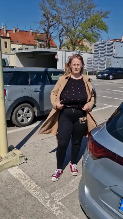 In the parking lot like in the parking lot, someone walks, someone parks the car and I just show my huge tits.