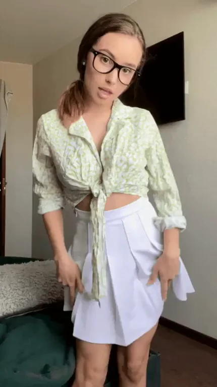 Nerdy Cutie in Glasses Teases with Skirt-Up Ass Flash