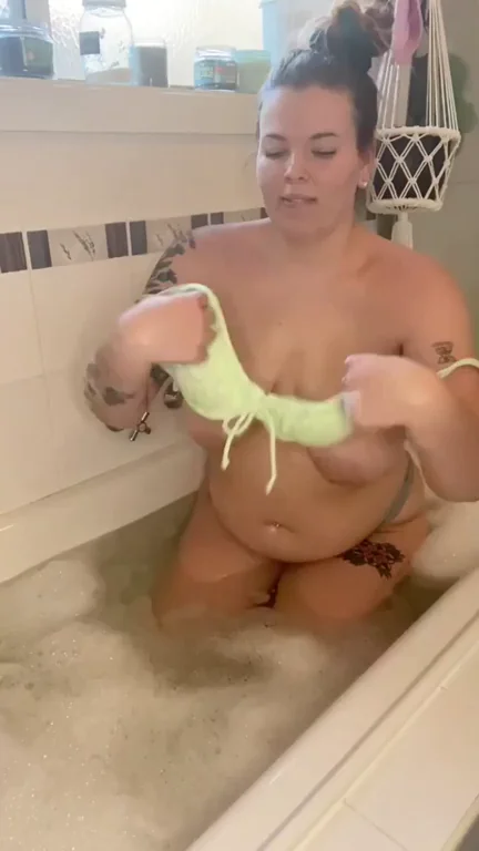 Thick Babe Teases with Neon Green Bikini Strip in the Tub